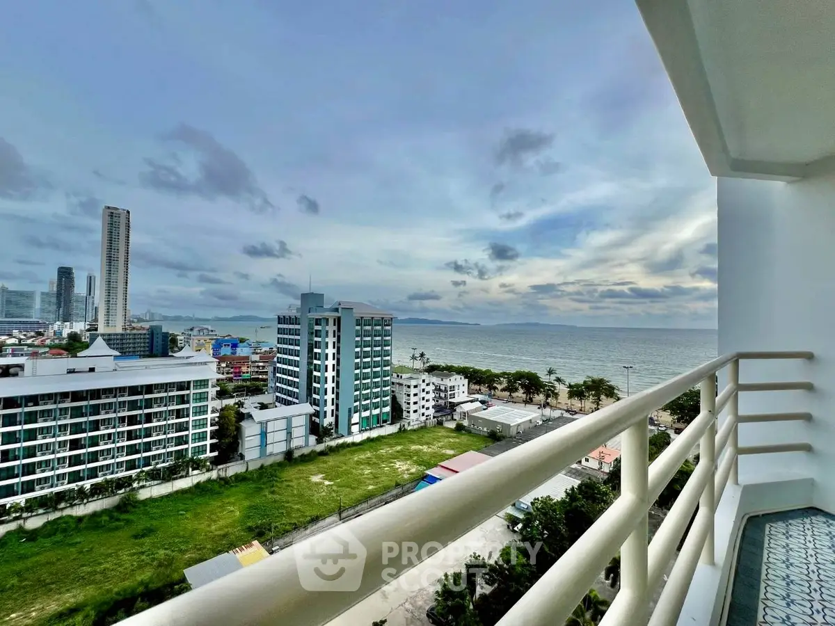 Stunning ocean view from high-rise balcony overlooking cityscape and coastline.