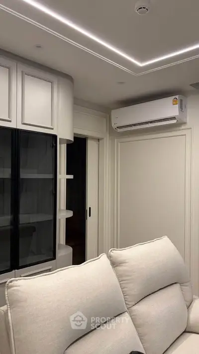 Modern living room with sleek design and built-in air conditioning unit.