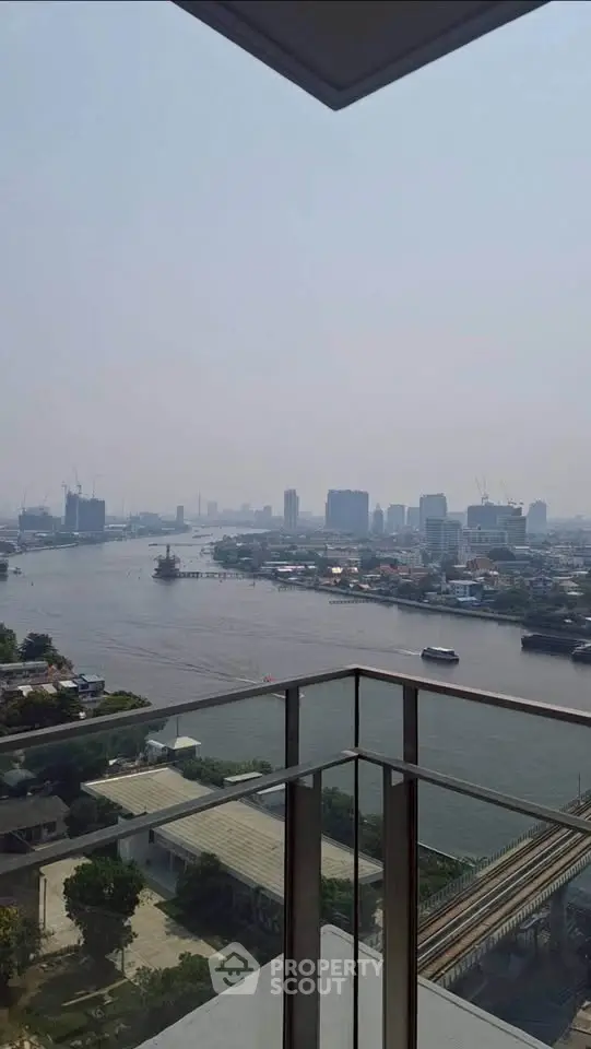 Stunning river view from high-rise balcony in urban setting, perfect for city living.