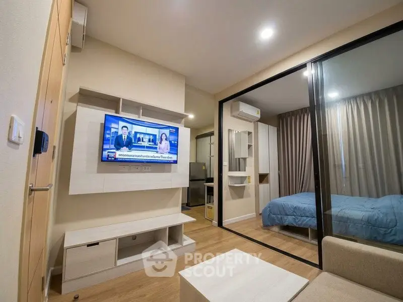 Modern studio apartment with glass partition and cozy living area