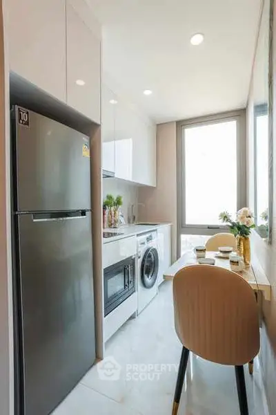 Modern kitchen with sleek appliances and cozy dining area