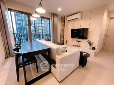 Modern living room with sleek furniture and city view balcony in luxury apartment.