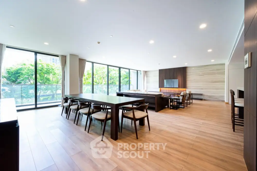 Spacious modern living room with large windows and elegant wooden flooring
