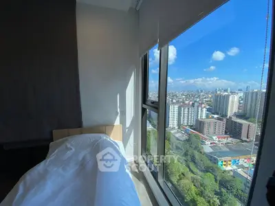 Stunning bedroom with floor-to-ceiling windows offering breathtaking city views.