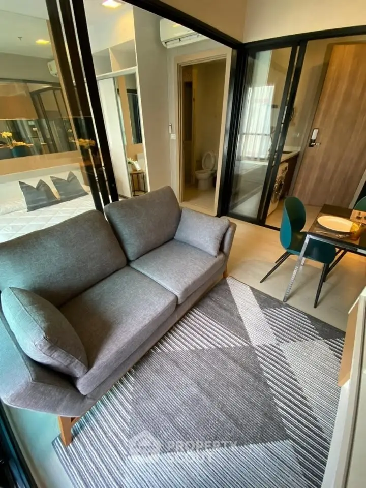 Modern apartment interior with cozy living area and stylish dining space.