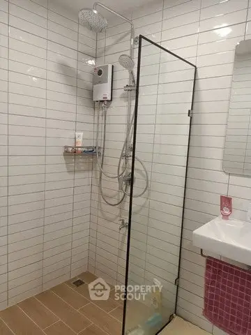 Modern bathroom with glass shower enclosure and sleek fixtures