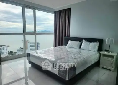 Luxurious bedroom with stunning ocean view in high-rise apartment
