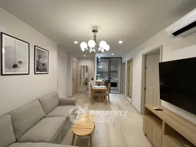 Modern living room with elegant decor and open kitchen layout