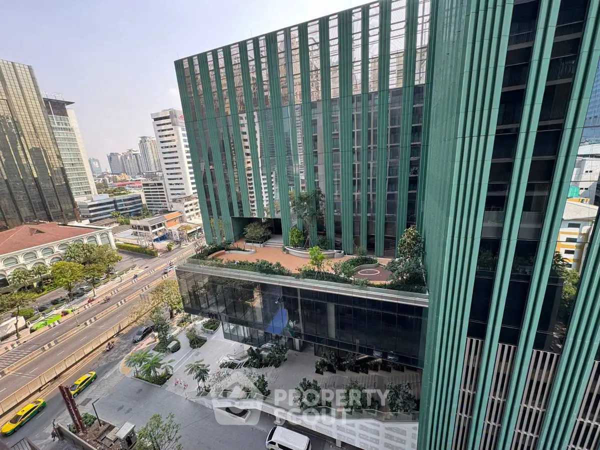 Stunning modern high-rise building with lush greenery and city views, perfect for urban living.
