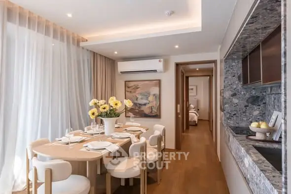 Elegant dining area with modern decor and natural light in a luxurious apartment.