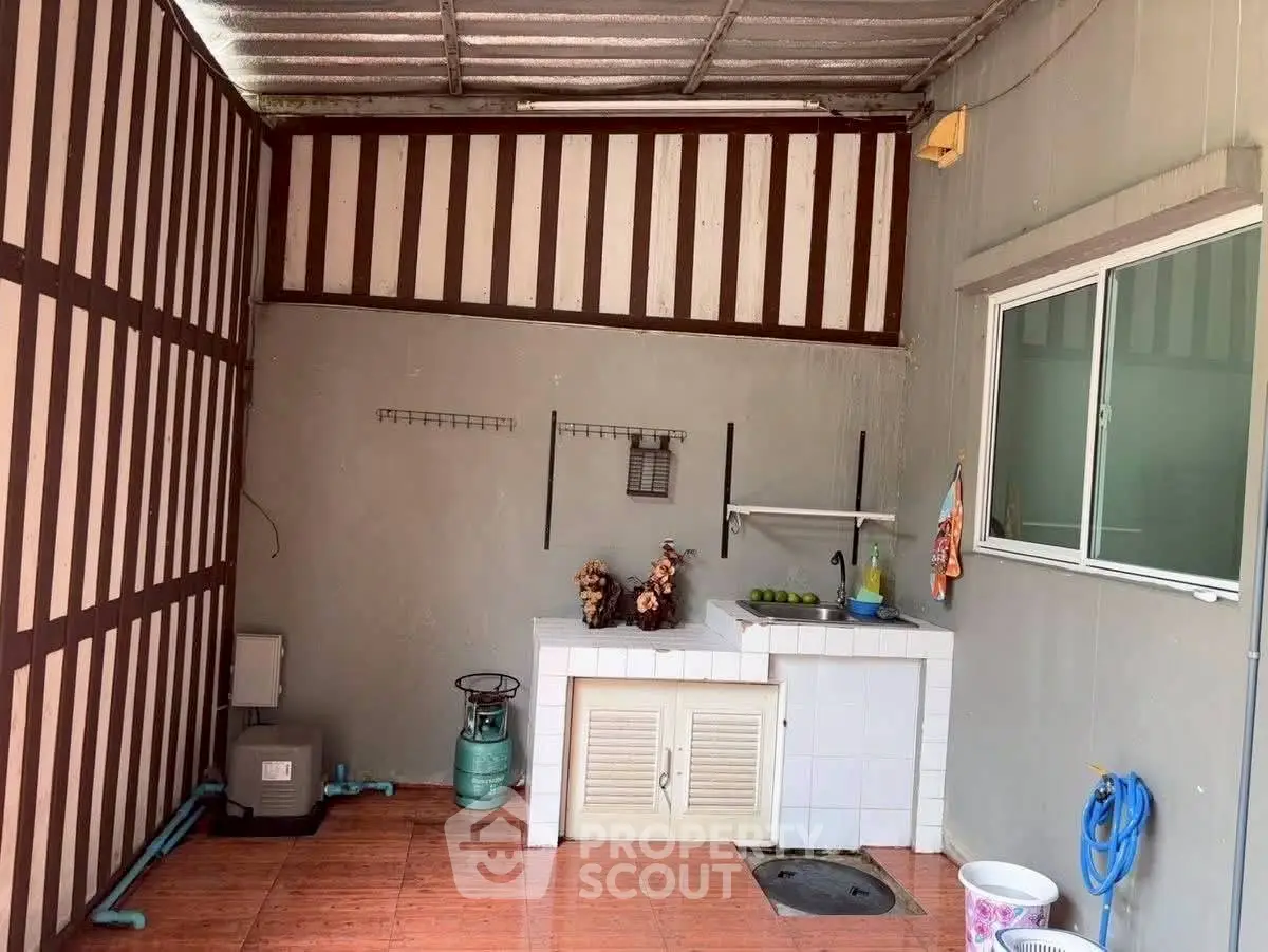 Charming outdoor kitchen with tiled floor and modern amenities