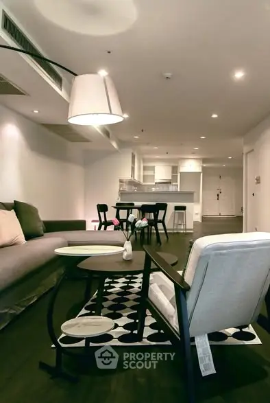 Modern living room with stylish furniture and open kitchen layout