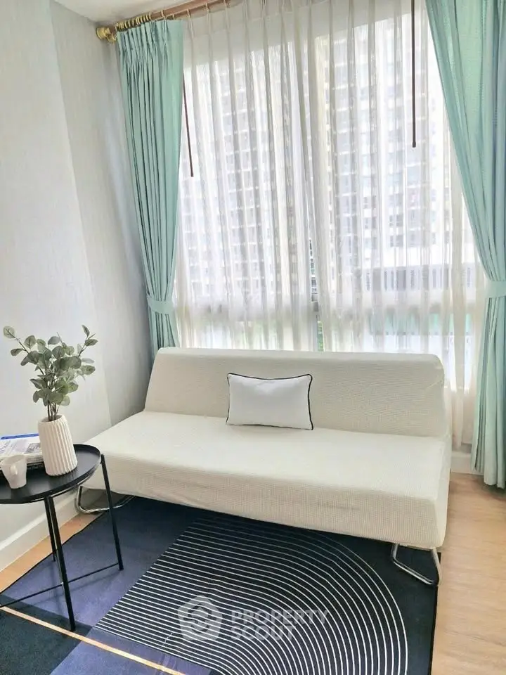Bright living room with modern sofa and large window view