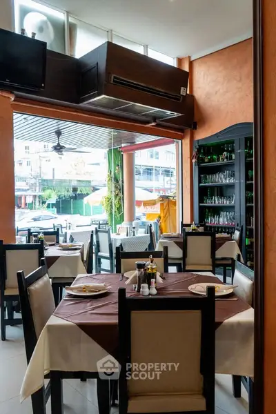 Charming restaurant interior with elegant table settings and glassware, offering a cozy dining experience.