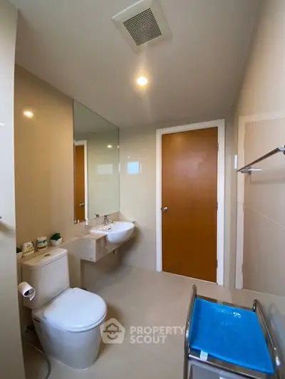 Modern bathroom with sleek fixtures and neutral tones, featuring a spacious layout and contemporary design.