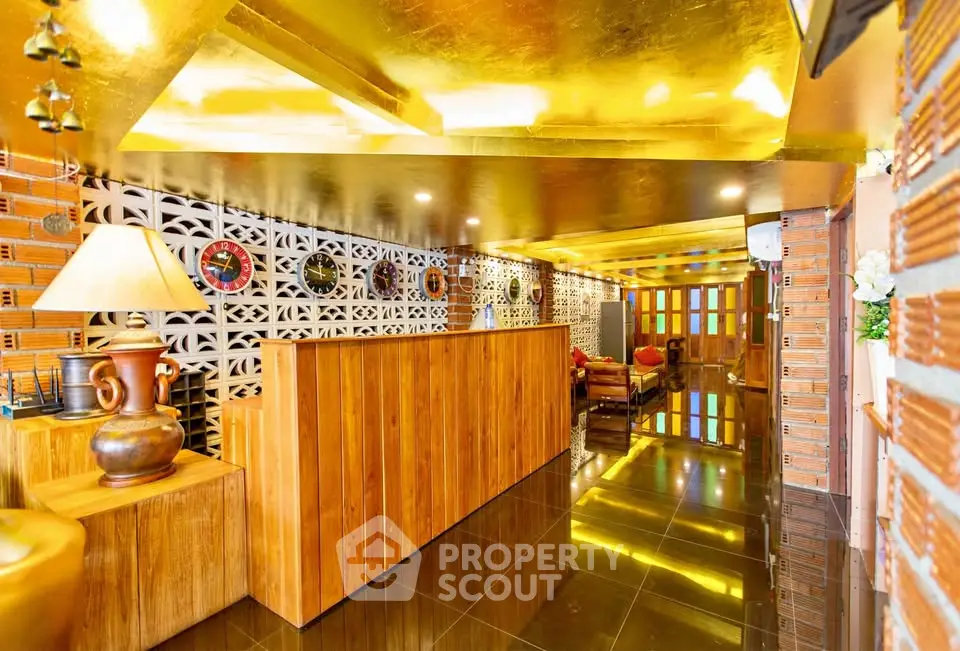 Luxurious lobby with golden ceiling and wooden accents in modern building