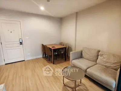 Cozy living room with modern furniture and wooden flooring in a stylish apartment.