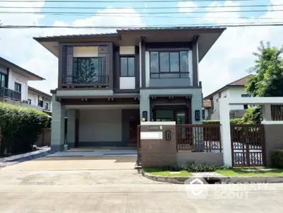 Modern two-story house with sleek design and spacious driveway in a suburban neighborhood.