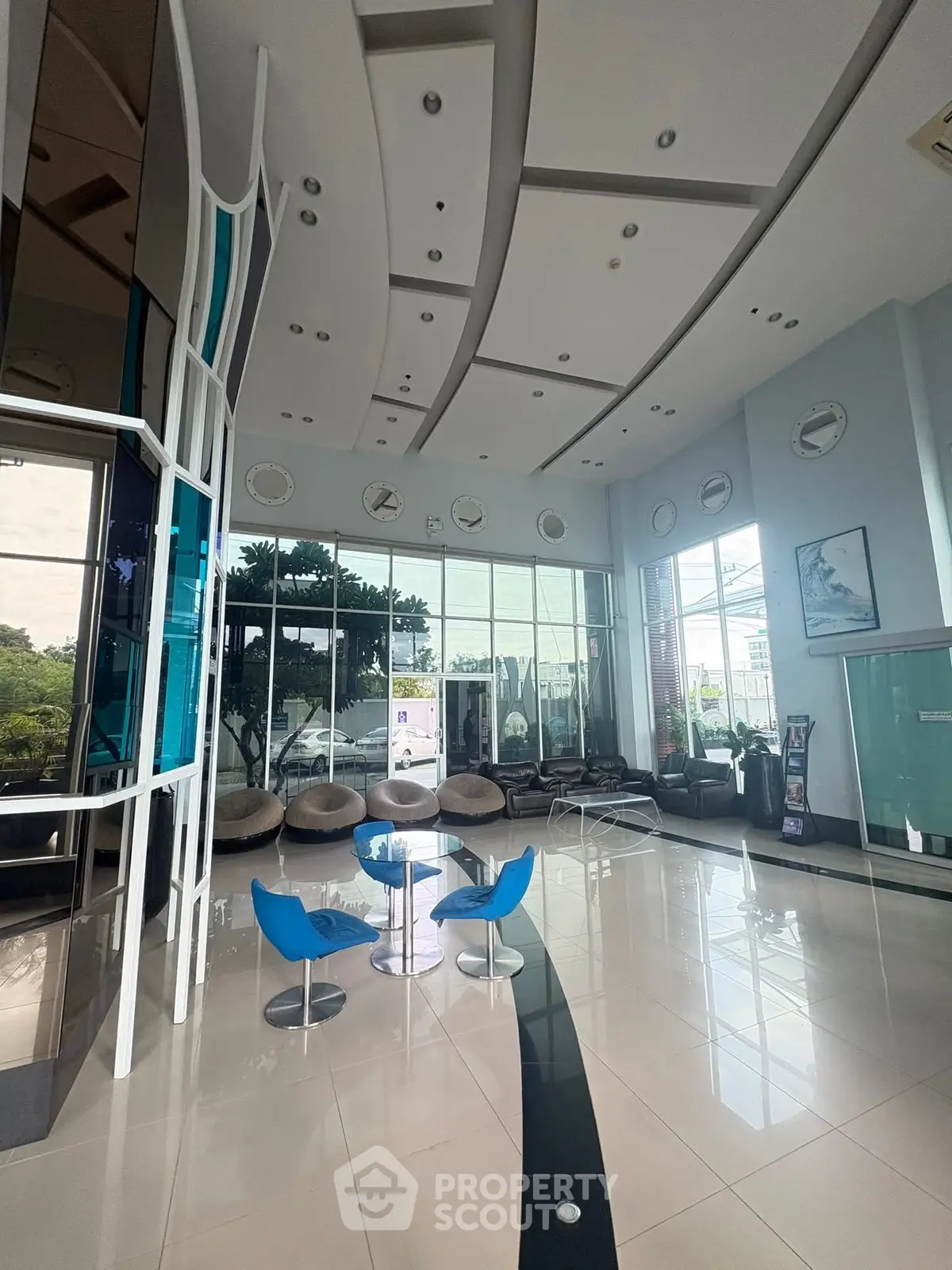 Modern building entrance with sleek design and stylish seating area