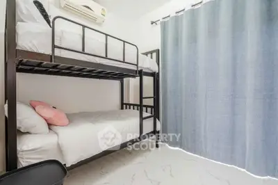 Cozy bedroom with bunk beds and modern decor, perfect for maximizing space in a compact living area.