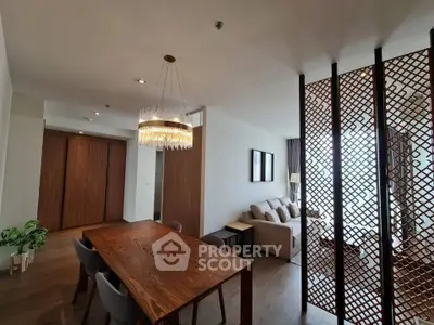 Spacious modern living room with elegant dining area and stylish wooden partition.
