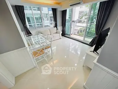 Modern living room with large windows, sleek furniture, and glossy tiled floors in a stylish apartment.