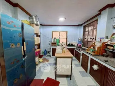 Spacious kitchen with unique fish-themed fridge and ample storage space.