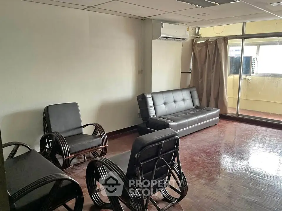 Spacious living room with modern furniture and large windows for natural light.