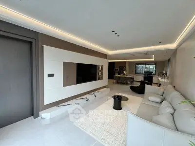 Modern living room with sleek design and open layout, featuring a cozy sofa and stylish decor.