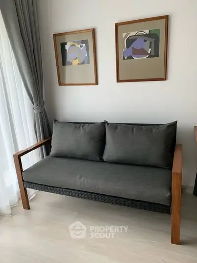 Modern living room with stylish sofa and abstract art on the wall.