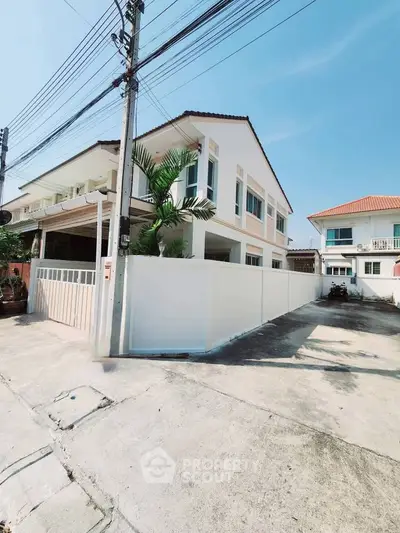 Charming two-story house with modern design and spacious driveway in a serene neighborhood.