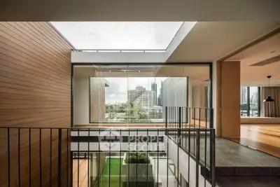 Modern architectural interior with open layout and city view, featuring sleek design and natural light.