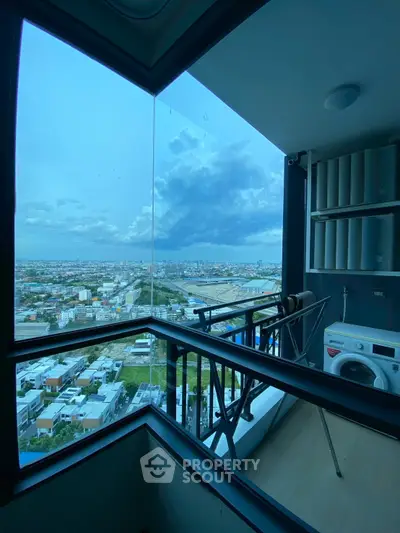 Stunning high-rise balcony with panoramic city view and modern amenities.