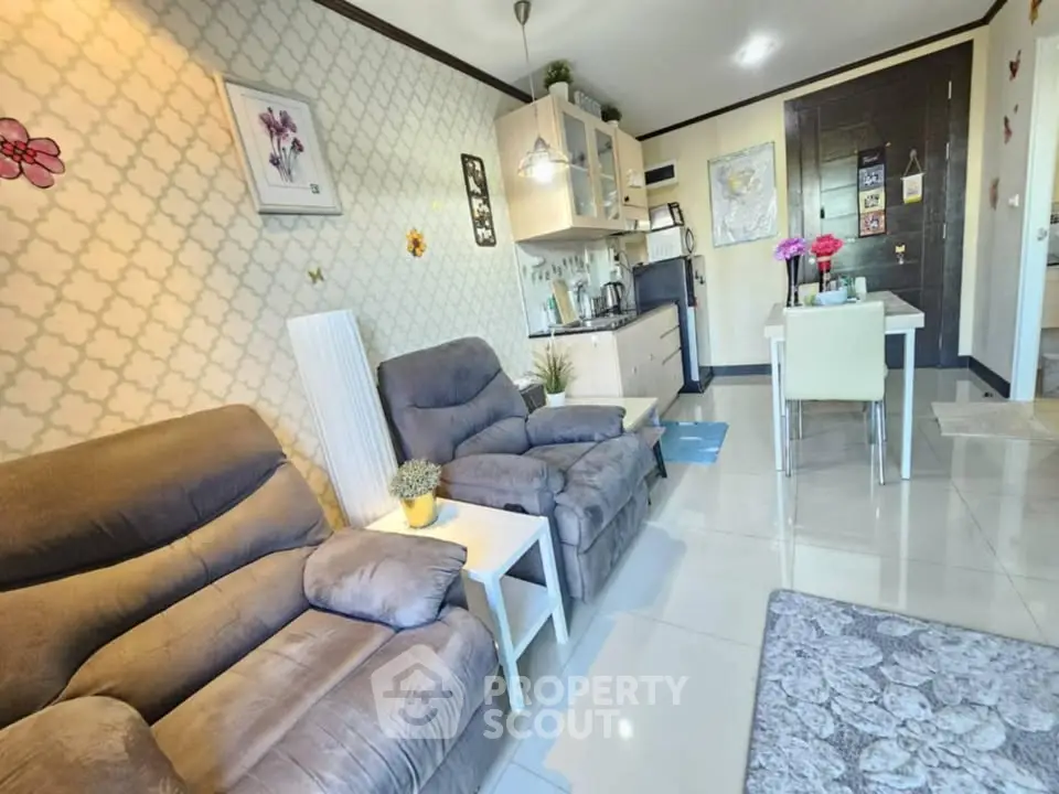 Cozy living room with plush seating and compact kitchen in modern apartment