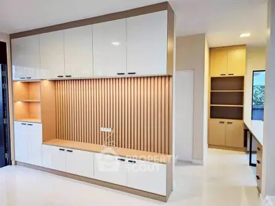 Modern living room with sleek built-in storage and elegant wood paneling