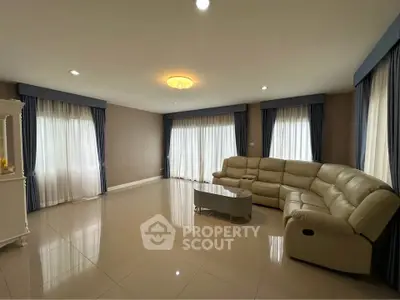 Spacious living room with elegant curtains and comfortable seating
