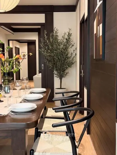 Elegant dining room with stylish wooden furniture and modern decor, perfect for sophisticated gatherings.