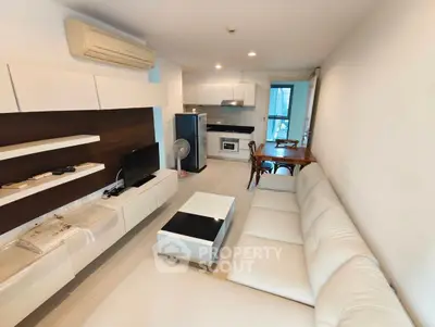 Modern living room with sleek furniture and open kitchen layout