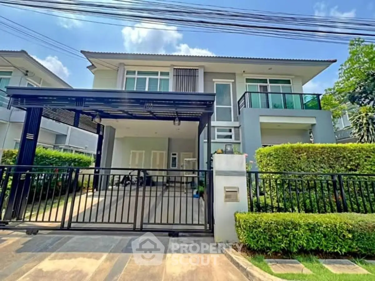 Modern two-story house with sleek design, spacious driveway, and lush greenery in a serene neighborhood.