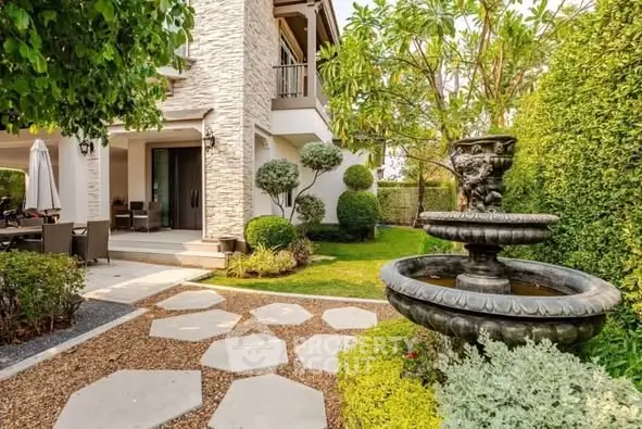 Charming garden with elegant stone fountain and lush greenery in luxury property