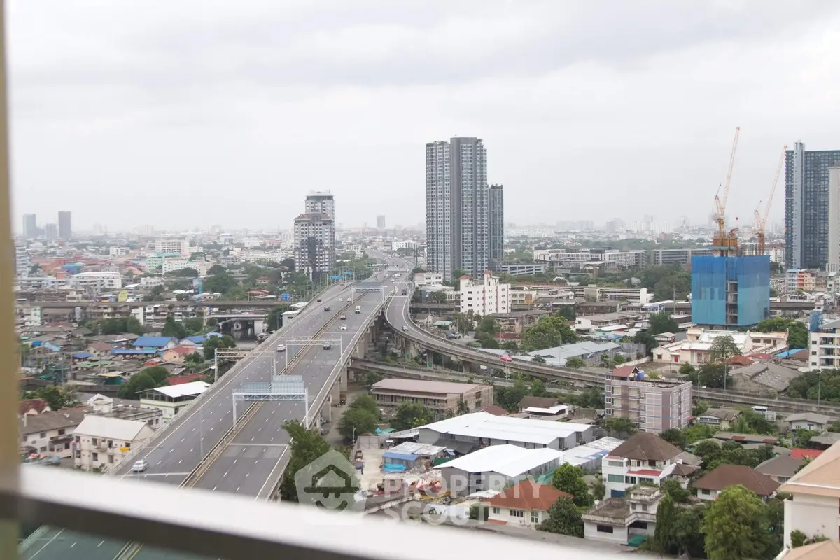 Stunning cityscape view with high-rise buildings and highway, perfect for urban living enthusiasts.
