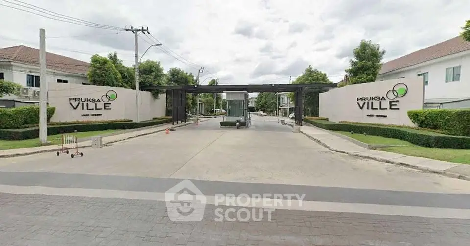 Elegant entrance of Pruksa Ville residential community with modern design and lush greenery.