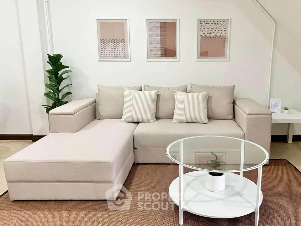 Stylish living room with modern beige sofa and chic decor