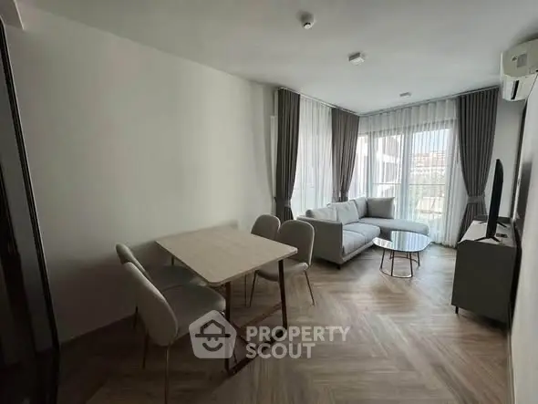 Modern living room with stylish furniture and large windows offering natural light.