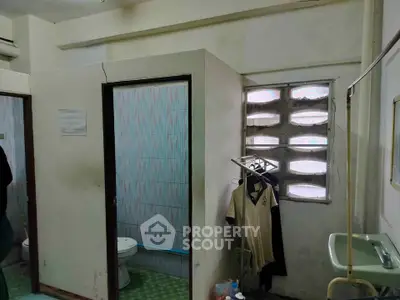 Modest bathroom with basic amenities and natural light
