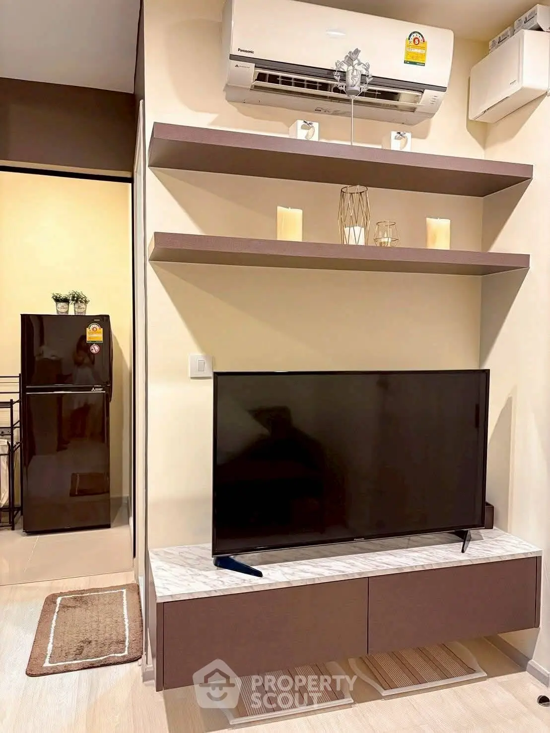 Modern living room with sleek TV setup and air conditioning