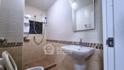 Modern bathroom with stylish tiles and sleek fixtures in a contemporary home.