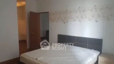 Spacious bedroom with elegant decor and comfortable bed in modern apartment.