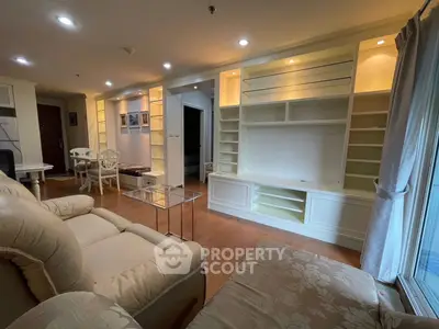 Spacious living room with elegant built-in shelving and cozy seating area.