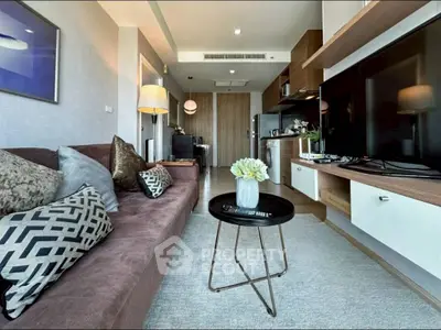 Modern living room with stylish decor and open kitchen layout